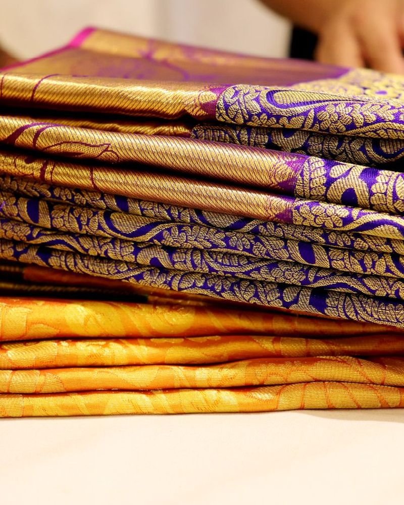 Folded silk sarees with gold borders
