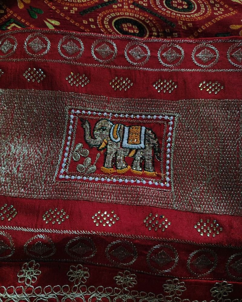 Red embroidered textile with an elephant motif