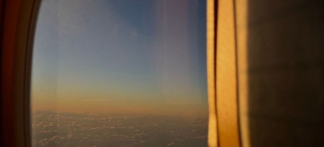 View from an aircraft window at sunrise