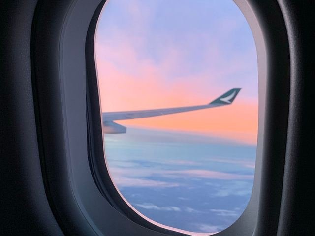 Looking out of an aircraft window at the clouds